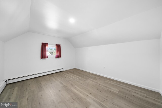 1504 Montgomery Rd, Wilmington, DE 19805 - additional living space featuring a baseboard radiator, lofted ceiling, baseboards, and wood finished floors