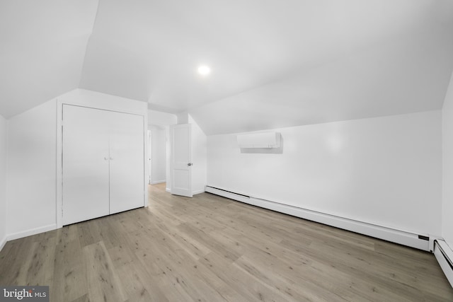 1504 Montgomery Rd, Wilmington, DE 19805 - additional living space with an AC wall unit, baseboards, wood finished floors, a baseboard radiator, and vaulted ceiling