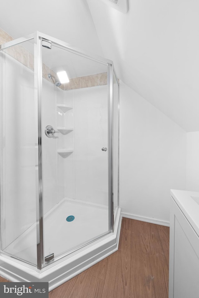 1504 Montgomery Rd, Wilmington, DE 19805 - bathroom featuring vaulted ceiling, a shower stall, and wood finished floors