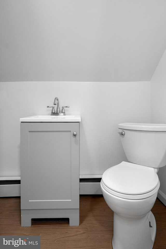 1504 Montgomery Rd, Wilmington, DE 19805 - half bath featuring vanity, toilet, baseboard heating, and wood finished floors