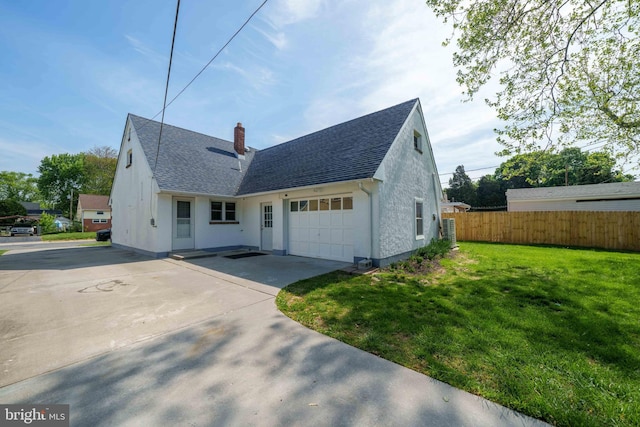 1504 Montgomery Rd, Wilmington, DE 19805 - exterior space featuring a garage, fence, a chimney, a shingled roof, and a yard