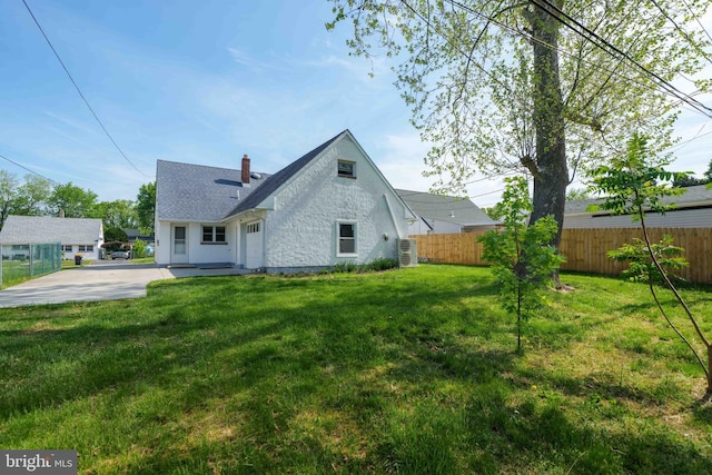 1504 Montgomery Rd, Wilmington, DE 19805 - rear view of house with fence, a chimney, a lawn, and a shingled roof