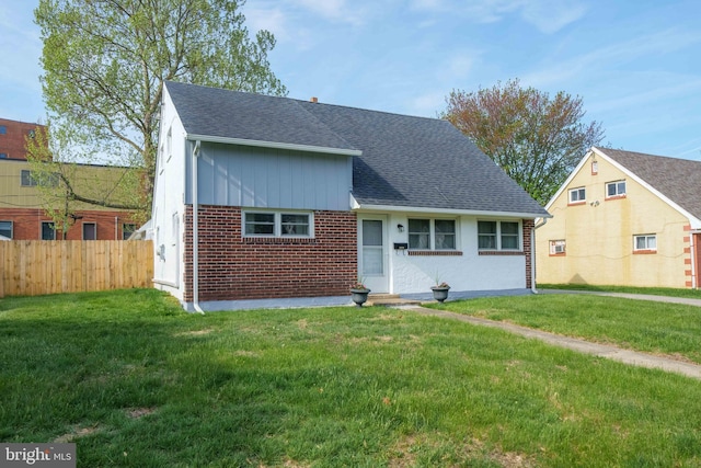 1504 Montgomery Rd, Wilmington, DE 19805 - view of front of home featuring fence, brick siding, roof with shingles, and a front yard