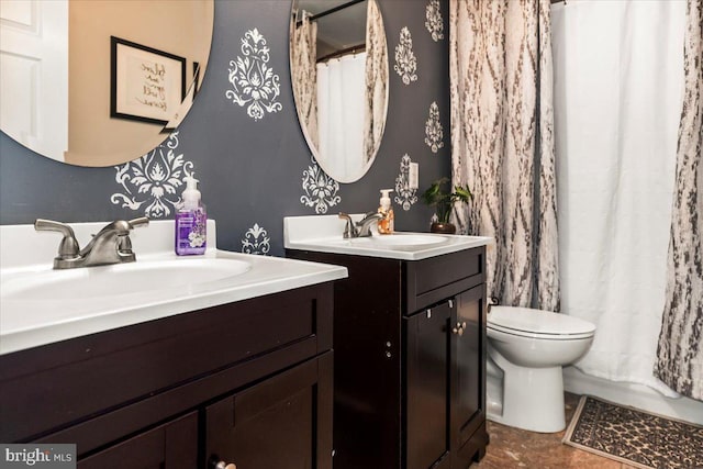 bathroom with a shower with shower curtain, toilet, two vanities, and a sink
