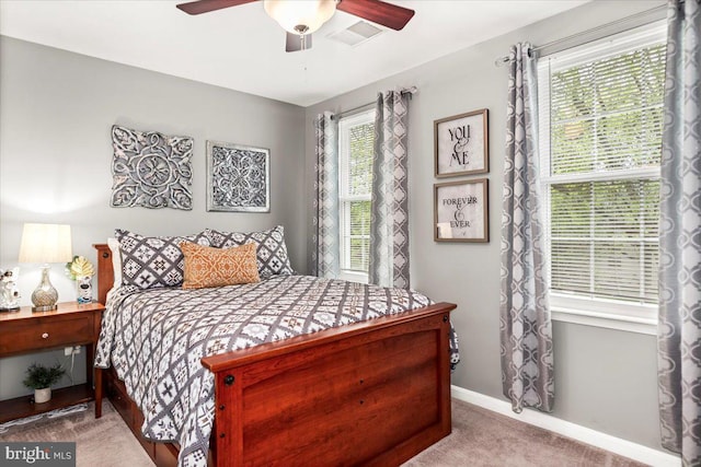bedroom with carpet flooring, a ceiling fan, baseboards, and visible vents