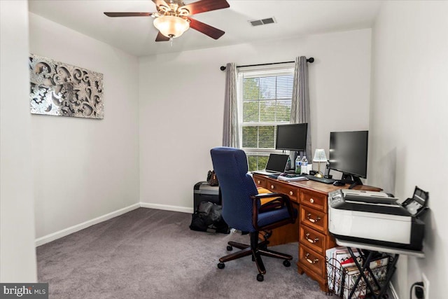 carpeted home office featuring visible vents, baseboards, and ceiling fan