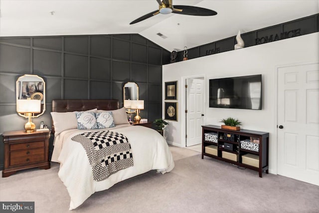 bedroom with visible vents, carpet, a decorative wall, and high vaulted ceiling