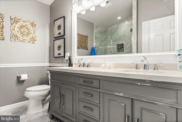 bathroom featuring double vanity, marble finish floor, toilet, a sink, and a stall shower