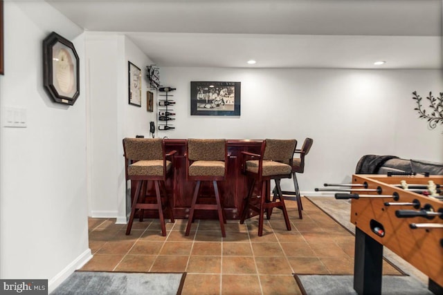 bar with recessed lighting, tile patterned floors, a dry bar, and baseboards