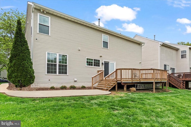 back of house with a lawn, a deck, and stairway