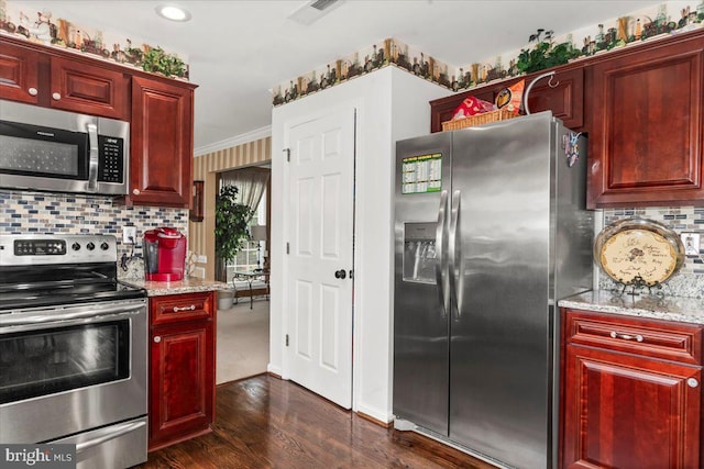 kitchen with dark wood-style flooring, visible vents, tasteful backsplash, reddish brown cabinets, and stainless steel appliances