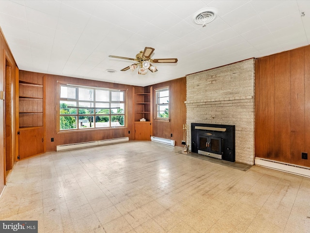 9618 Hall Rd, Frederick, MD 21701 - unfurnished living room with baseboard heating, wooden walls, built in shelves, a ceiling fan, and tile patterned floors