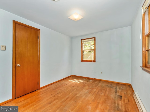 9618 Hall Rd, Frederick, MD 21701 - spare room featuring a baseboard heating unit, light wood-type flooring, and baseboards