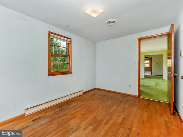 9618 Hall Rd, Frederick, MD 21701 - unfurnished room featuring a baseboard heating unit, wood finished floors, plenty of natural light, and baseboards
