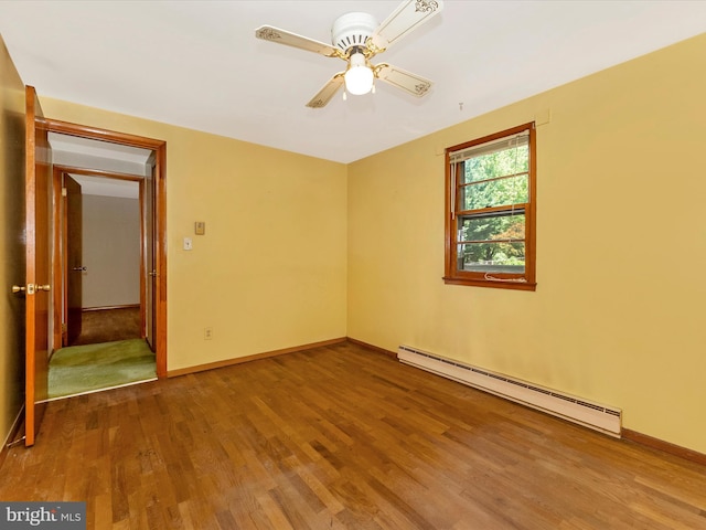9618 Hall Rd, Frederick, MD 21701 - empty room featuring baseboard heating, wood finished floors, a ceiling fan, and baseboards
