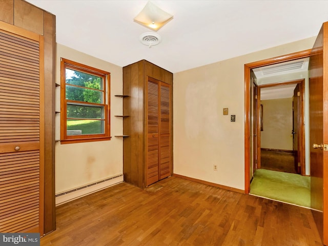 9618 Hall Rd, Frederick, MD 21701 - unfurnished bedroom with baseboard heating, wood finished floors, and baseboards