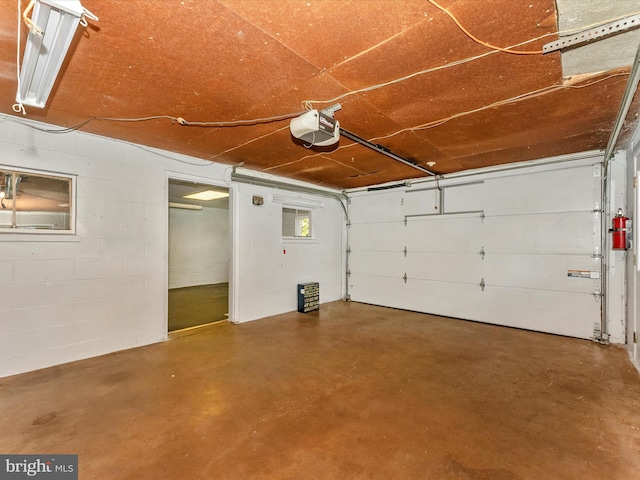 9618 Hall Rd, Frederick, MD 21701 - garage featuring a garage door opener and concrete block wall