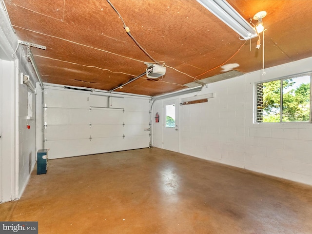 9618 Hall Rd, Frederick, MD 21701 - garage featuring a garage door opener and concrete block wall