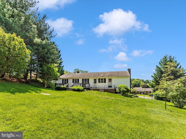 9618 Hall Rd, Frederick, MD 21701 - view of front facade featuring a front lawn, a deck, and a chimney