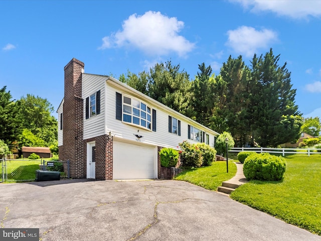 9618 Hall Rd, Frederick, MD 21701 - view of front of home featuring a chimney, asphalt driveway, an attached garage, and brick siding