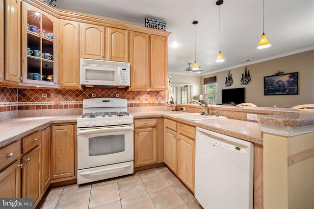 kitchen with backsplash, light brown cabinetry, a sink, a peninsula, and white appliances