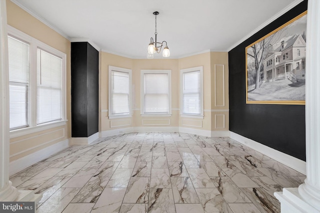 unfurnished dining area featuring crown molding, baseboards, and an inviting chandelier
