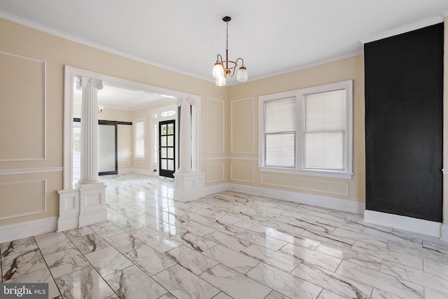unfurnished dining area featuring ornate columns, ornamental molding, marble finish floor, and a decorative wall