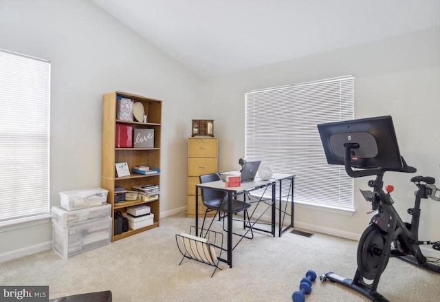 carpeted office with baseboards, visible vents, and lofted ceiling