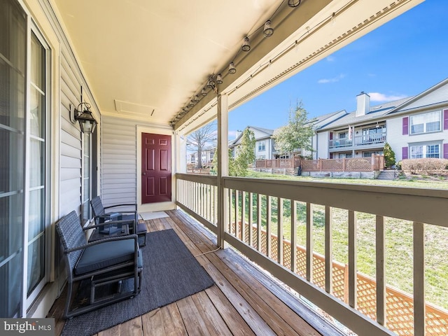 wooden terrace with a porch and a residential view
