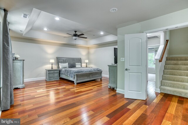 7140 Barry Rd, Alexandria, VA 22315 - bedroom with wood-type flooring, a raised ceiling, baseboards, recessed lighting, and ceiling fan