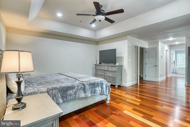 7140 Barry Rd, Alexandria, VA 22315 - bedroom featuring wood finished floors, a raised ceiling, baseboards, and recessed lighting