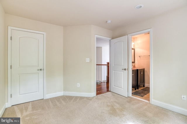 7140 Barry Rd, Alexandria, VA 22315 - unfurnished bedroom featuring light carpet, baseboards, and ensuite bathroom