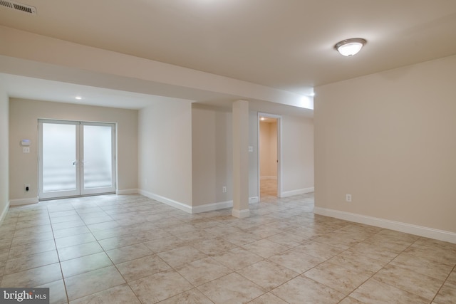 7140 Barry Rd, Alexandria, VA 22315 - empty room featuring light tile patterned floors, french doors, and baseboards