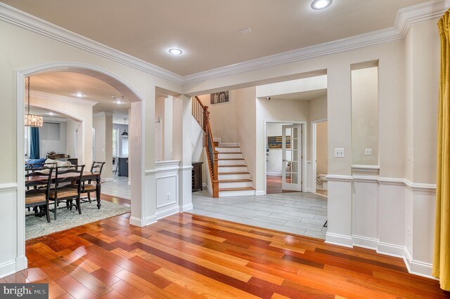 7140 Barry Rd, Alexandria, VA 22315 - foyer with hardwood / wood-style floors, ornamental molding, stairs, arched walkways, and recessed lighting