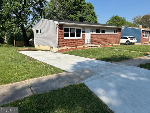 9016 Samoset Rd, Randallstown, MD 21133 - view of front of house with concrete driveway, a front yard, and brick siding