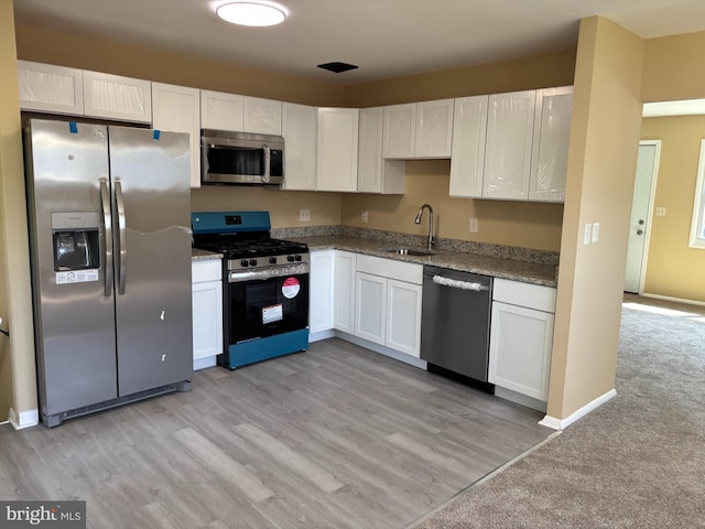 9016 Samoset Rd, Randallstown, MD 21133 - kitchen with a sink, white cabinetry, stone counters, and stainless steel appliances