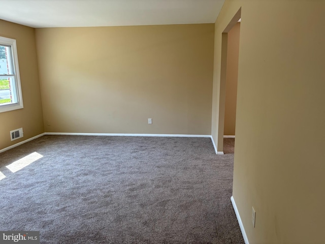 9016 Samoset Rd, Randallstown, MD 21133 - unfurnished room with baseboards, dark colored carpet, and visible vents