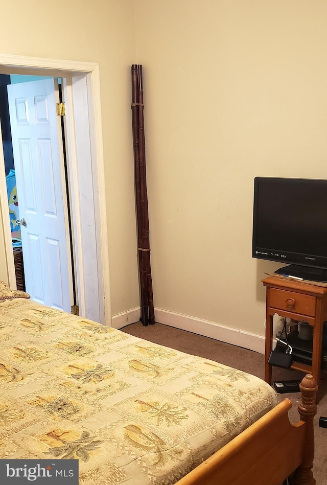 carpeted bedroom featuring baseboards