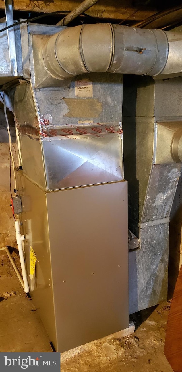 utility room featuring heating unit