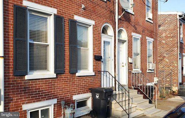 view of side of home with brick siding