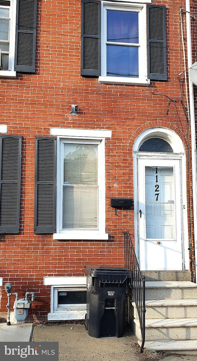 property entrance with brick siding