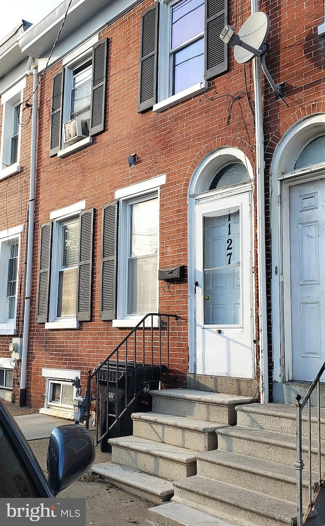 property entrance featuring brick siding