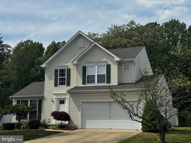 traditional-style home featuring driveway, a garage, and roof with shingles