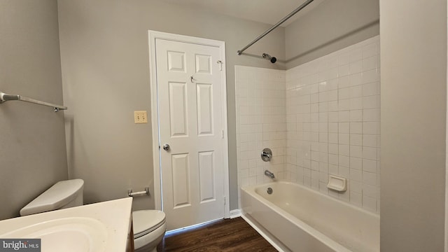 full bath with toilet, tub / shower combination, wood finished floors, and vanity