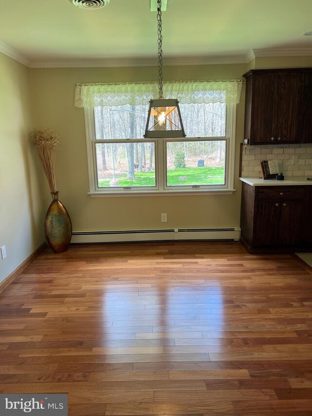 265 Asbury Rd, Egg Harbor Township, NJ 08234 - unfurnished dining area with ornamental molding, baseboard heating, and wood finished floors