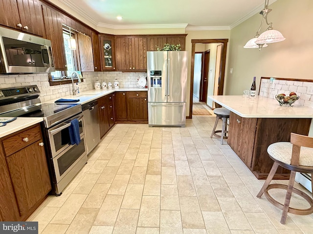 265 Asbury Rd, Egg Harbor Township, NJ 08234 - kitchen with tasteful backsplash, light countertops, ornamental molding, a breakfast bar, and stainless steel appliances