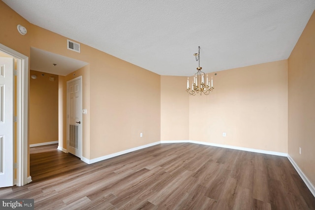 3200 N Leisure World Blvd Unit 1010, Silver Spring, MD 20906 - unfurnished dining area with a chandelier, wood finished floors, baseboards, and a textured ceiling