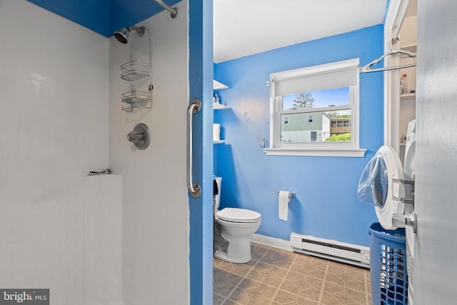 bathroom featuring walk in shower, toilet, a baseboard heating unit, and baseboards