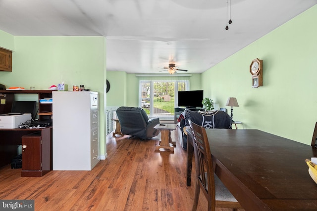 dining room with a ceiling fan and wood finished floors
