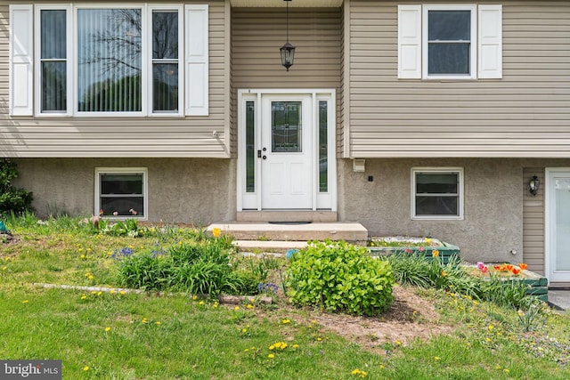 doorway to property with stucco siding